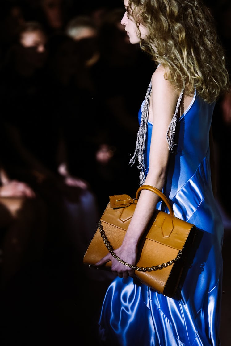A model in a blue slip dress from Louis Vuitton’s Fall 2017 collection walking the runway.