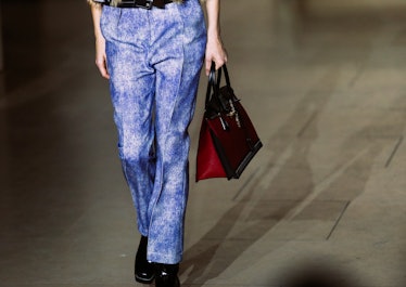 A model walking the runway in blue pants from Louis Vuitton’s Fall 2017 collection.