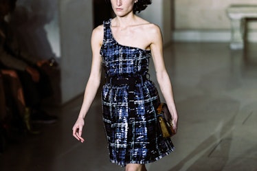 A model in Louis Vuitton’s Fall 2017 blue plaid one-shoulder dress walking the runway.