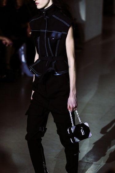 A model in black pants and a black leather peplum top walking the runway for Louis Vuitton’s Fall 20...