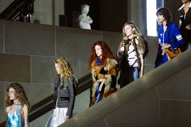 Models in looks from Louis Vuitton’s Fall 2017 collection walking down the stairs.