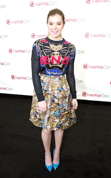 Hailee Steinfeld posing in a fierce top and skirt by Kenzo with candy blue Nicholas Kirkwood heels