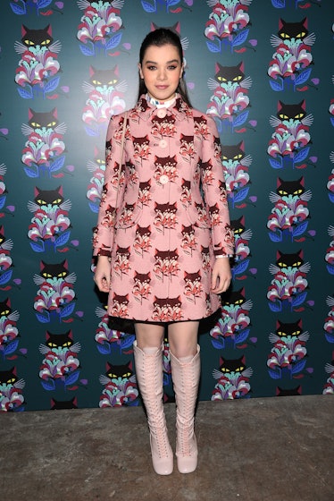 Hailee Steinfeld posing for a photo while wearing a pink, printed Miu Miu coat