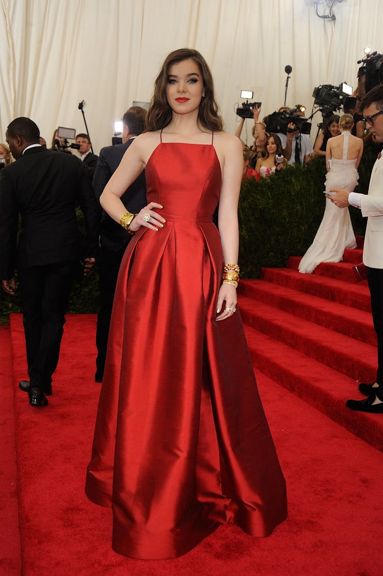 Hailee Steinfeld posing in a red ball gown