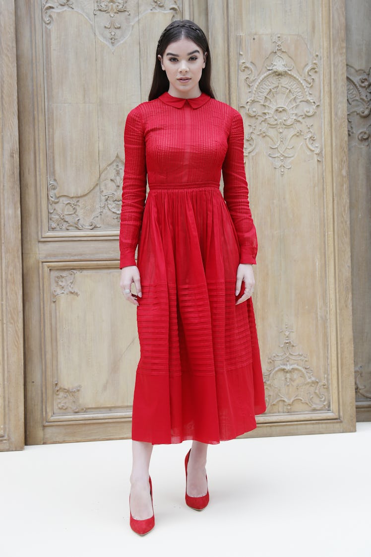 Hailee Steinfeld posing in a red dress