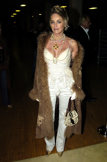 Sharon Stone in a corset going-out top, piles of necklaces, and miniature Fendi bag