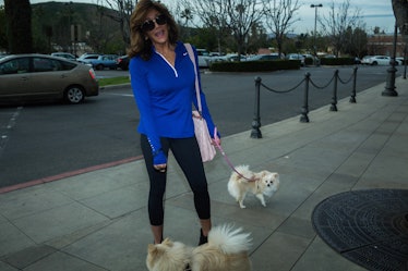 Calabasas resident wearing sports clothes while taking out her two small dogs