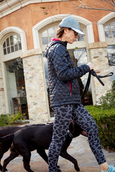 A woman wearing sports clothes walking her dogs in Calabasas