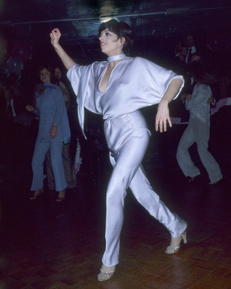 Liza dances in purple silk jumpsuit