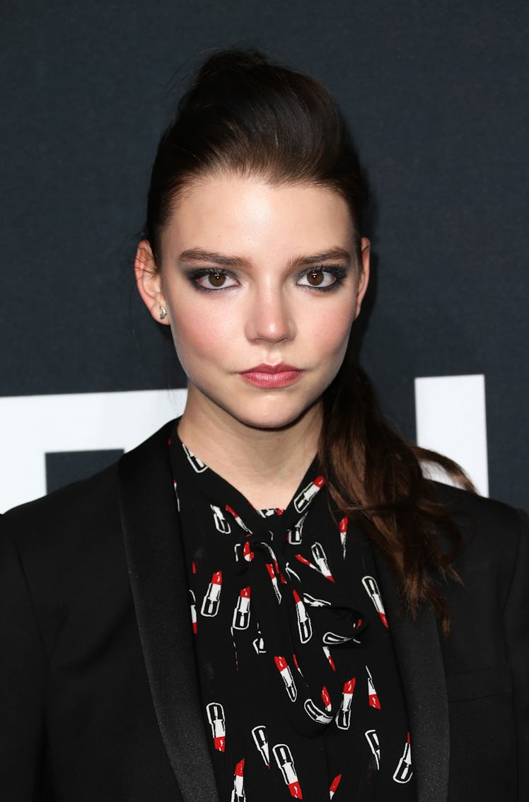 Taylor-Joy at the Saint Laurent show wearing a twisted high pony with a dark smoky eye