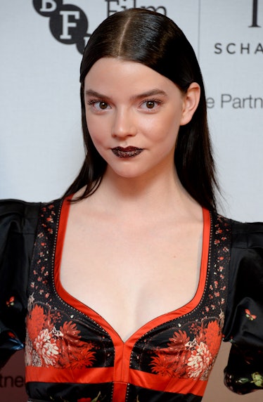 Taylor-Joy at the IWC Gala wearing her straight hair in a sleek, middle-parted ‘do with a Gothic bur...