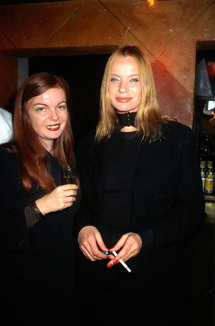 Martine Sitbon, a Chloé’s revered designer, posing for a photograph with a friend while holding a sh...