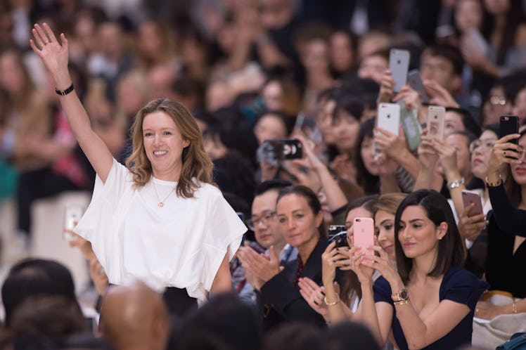 Clare Waight Keller waving before she takes her final bow as creative director of Chloé.