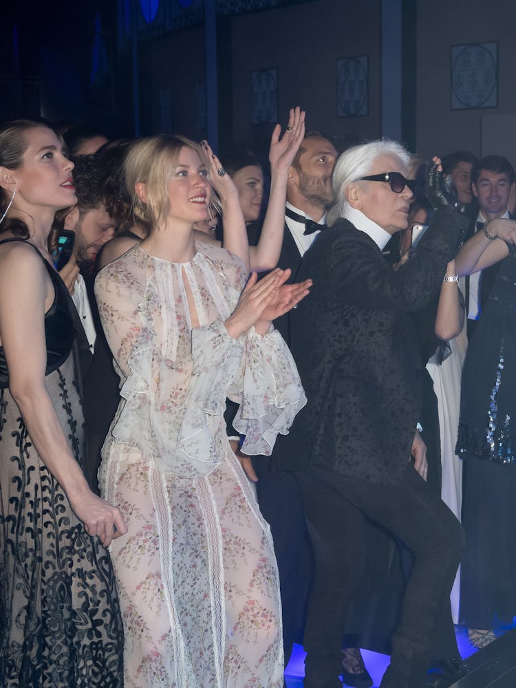 Designer Karl Lagerfeld blows a kiss to a performer during the Rose Ball in Monte Carlo, Monaco