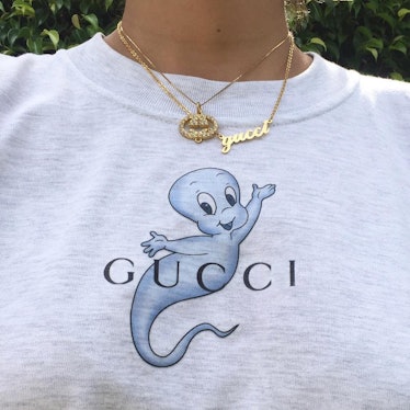 Ava Nirui wearing a grey Gucci sweatshirt with Casper the Friendly Ghost on it, and a Gucci necklace...