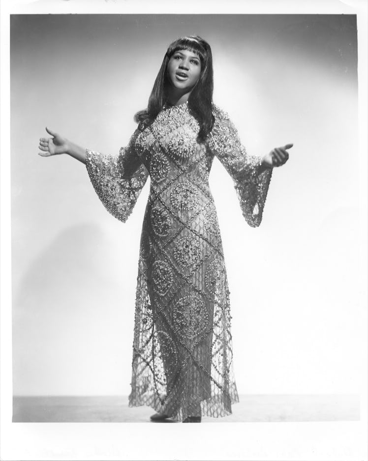 Aretha Franklin performing in an embellished bell-sleeve caftan