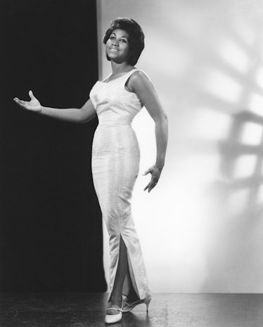 Aretha Franklin posing in a cream pencil dress in 1964