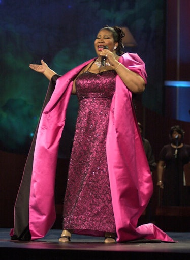 Aretha Franklin in a fuchsia and black patterned gown paired with a satin fuchsia and black shawl in...