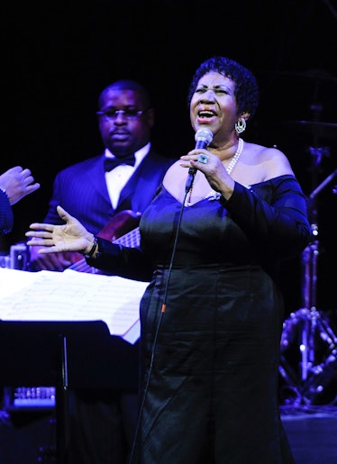 Aretha Franklin in a black gown performing in 2011