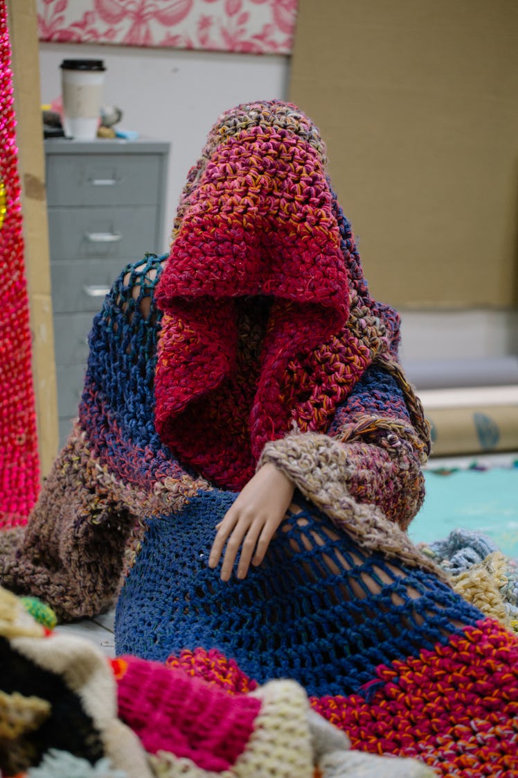 A woman wearing a knit hooded coat by Raúl de Nieves