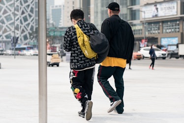 Two fashion-forward individuals strutting their street style during Seoul Fashion Week.