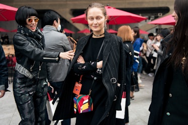 Two fashion-conscious women showing off their stylish outfits at Seoul Fashion Week.
