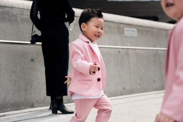 A toddler wearing a pink suit during Seoul Fashion Week.