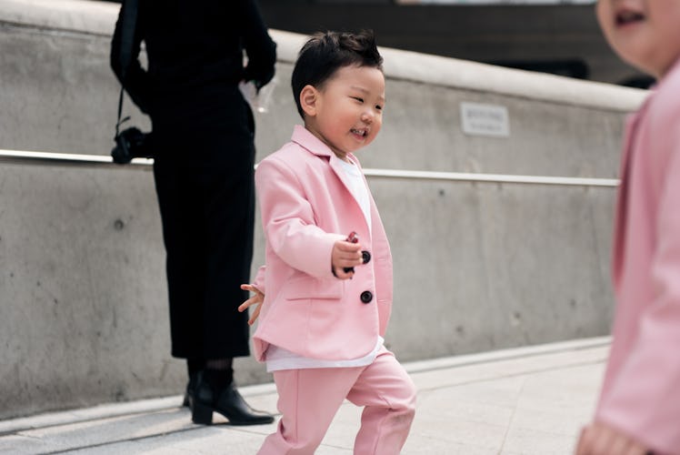 A toddler wearing a pink suit during Seoul Fashion Week.