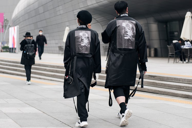 Two fashion enthusiasts parading their matching cutting-edge street style outfits during Seoul Fashi...