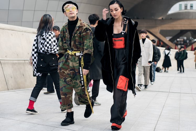 A stylish duo showcasing their fashion flair at Seoul Fashion Week.