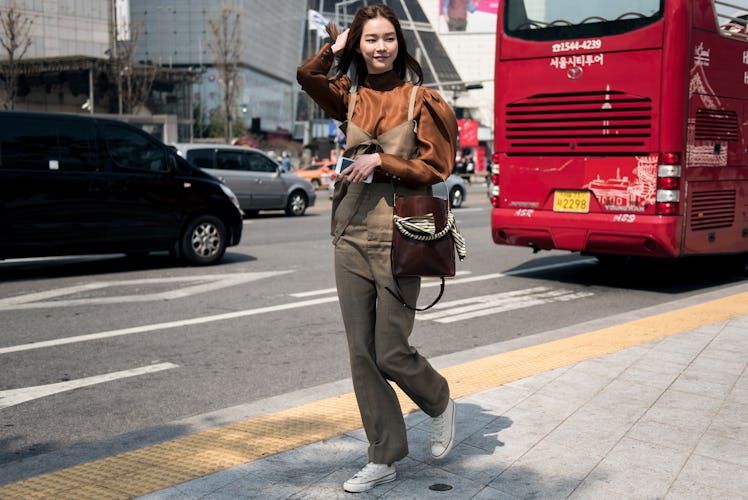 Fashion-forward individual expressing her creativity during Seoul Fashion Week.