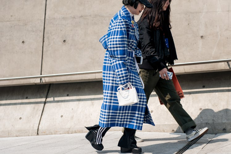 Trendsetters displaying their one-of-a-kind style on the streets of Seoul during Fashion Week.