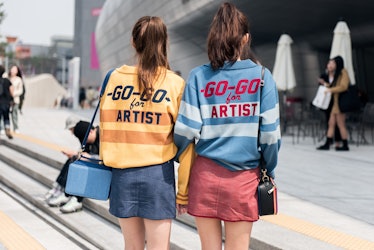 Fashion-forward individuals wearing matching outfits during Seoul Fashion Week.