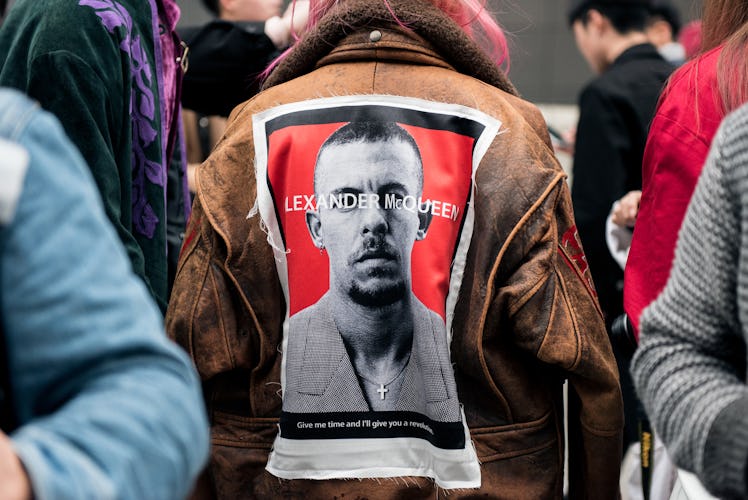 A person wearing Alexander McQueen brown leather jacket in the street of Seoul.