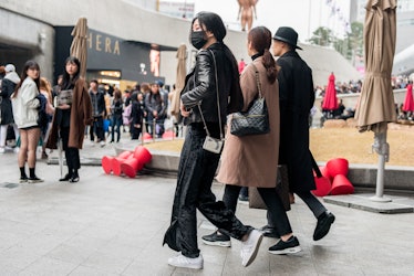 Trendsetting personalities displaying their fashion choices in Seoul.