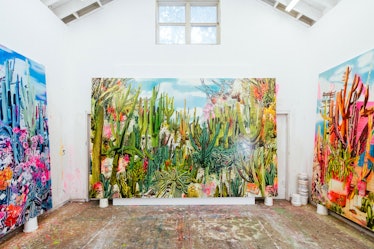 The inside of Rosson Crow studio with three multi-colored abstract paintings