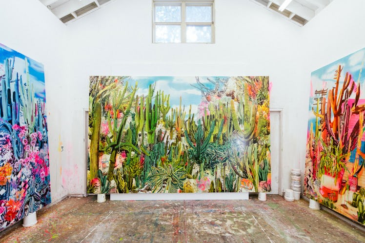 The inside of Rosson Crow studio with three multi-colored abstract paintings