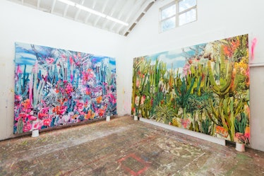 The inside of Rosson Crow studio with two multi-colored abstract paintings; one in mostly blue and t...