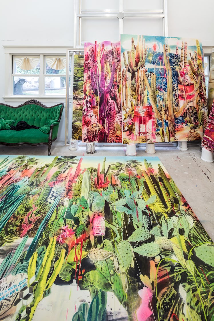 The inside of Rosson Crow studio with a green cactus print rug, a green couch and two large multi-co...