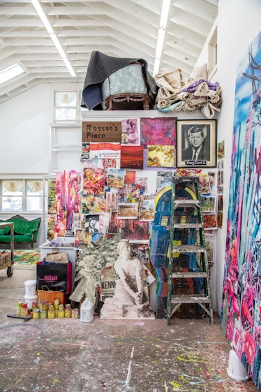 The inside of Rosson Crow studio with several paintings, stickers and sculptures