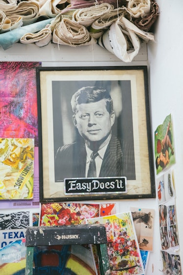 The inside of Rosson Crow studio with a portrait of John F. Kennedy and the text EasyDoesIt and othe...
