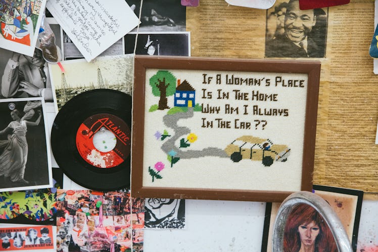 Embroidered image 'If a woman's place is in the home why am I always in the cart?' and stickers on a...