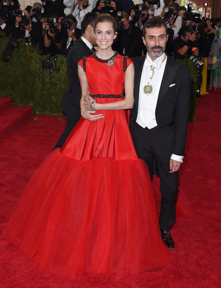 Allison Williams posing in a red gown at the Met’s Costume Institute Gala opening “China: Through th...