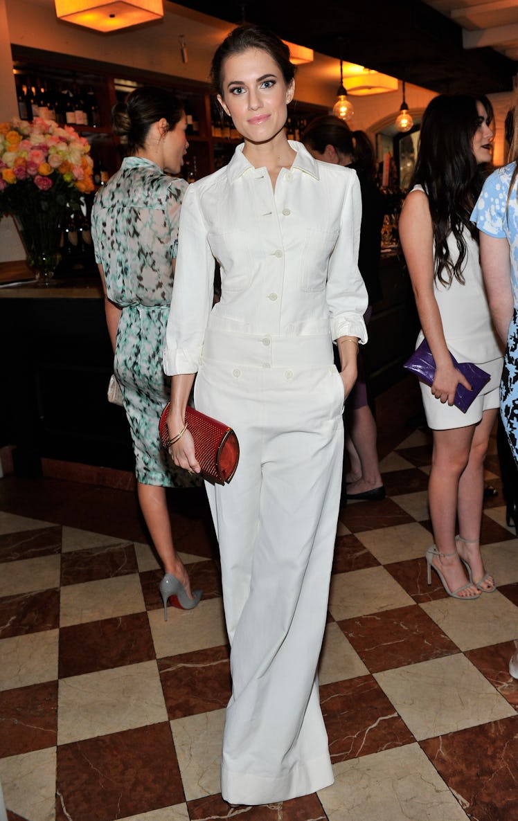 Allison Williams posing in a white dress at the Lynn Hirschberg Celebrates W's It Girls 