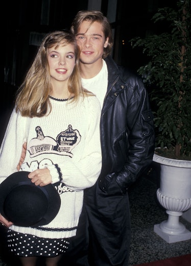 Brad Pitt standing next to Shalane McCall and smiling