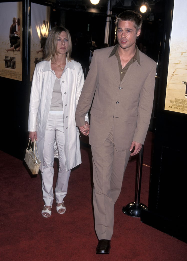 Jennifer Aniston and Brad Pitt dressed up and holding hands
