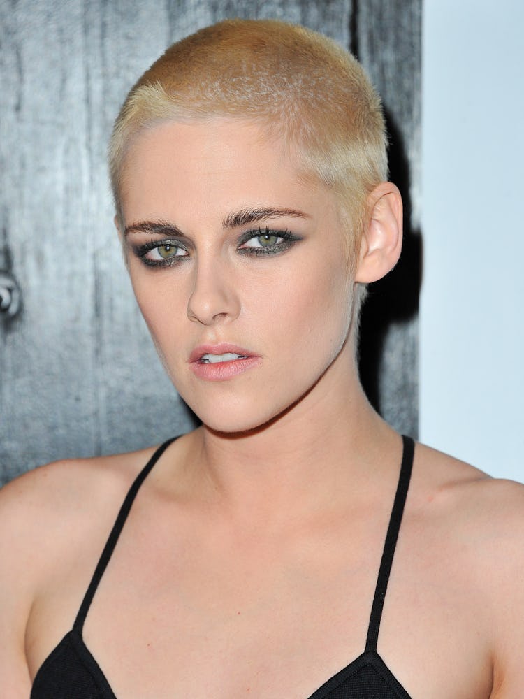Kristen Stewart with a short haircut in a black dress during a red carpet event