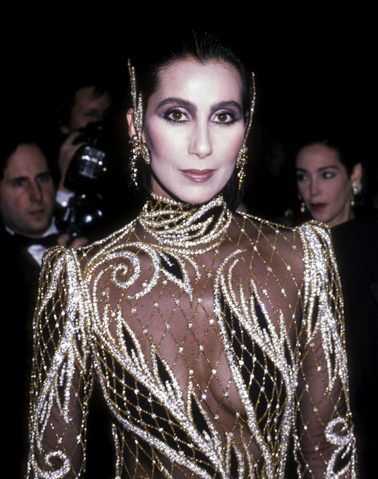 Cher wearing a gold and black dress at the Met Gala