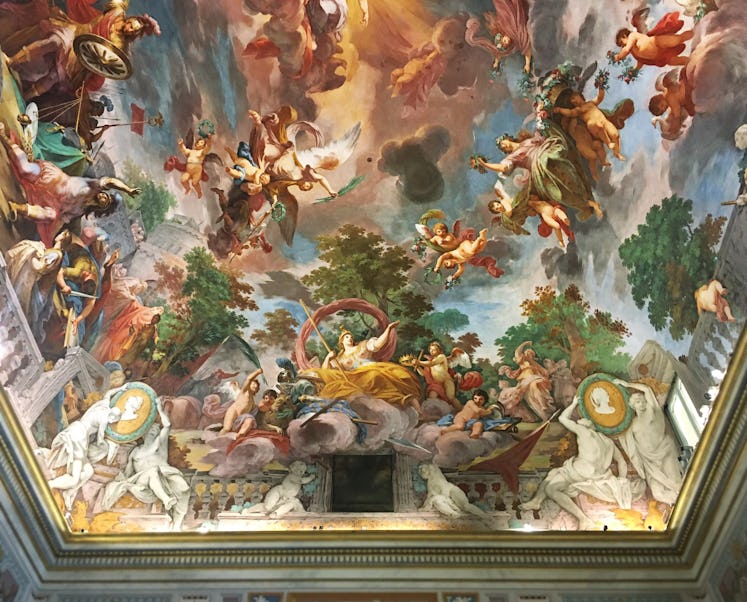 the ceiling at the Villa Borghese depicting various characters, building and the sky
