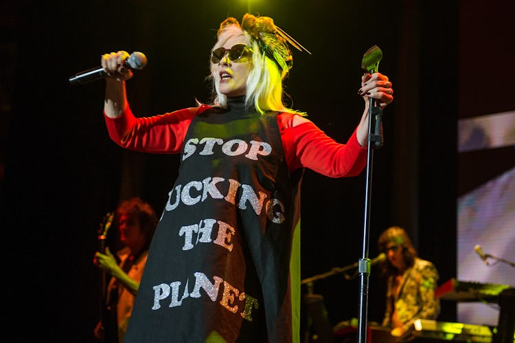 Debbie Harry in a black-red dress with the text 'STOP FUCKING THE PLANET'